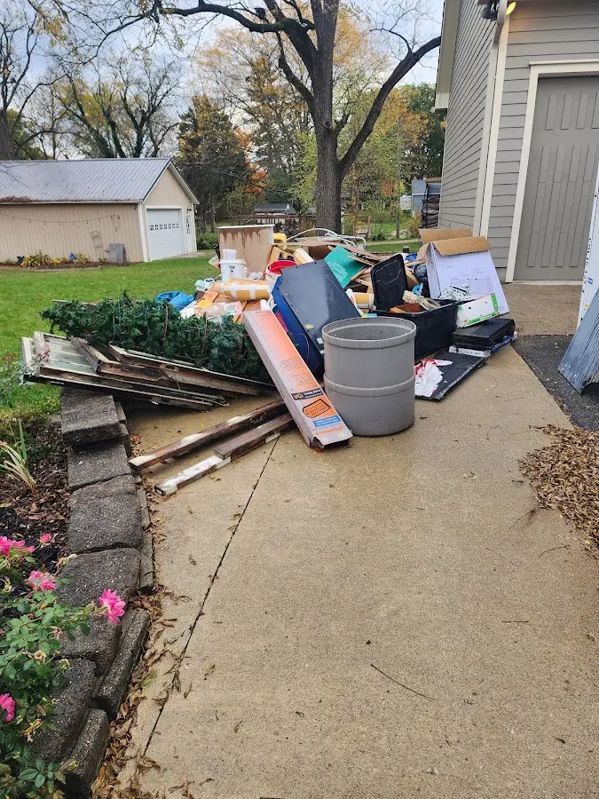 Dumpster being loaded with debris for Roofing Dumpster Rental in Fergus Falls